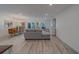 Open-concept living room featuring contemporary furnishings and hardwood floors at 2700 Bayshore Blvd # 588, Dunedin, FL 34698