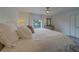 Cozy main bedroom with plush bedding, ceiling fan, and views of the front yard at 2700 Bayshore Blvd # 588, Dunedin, FL 34698