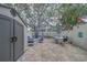 Outdoor patio with an umbrella-covered table and a shed for storage at 2700 Bayshore Blvd # 588, Dunedin, FL 34698