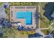 Aerial view of a stunning community pool with abundant lounge chairs and palm tree accents at 2700 Bayshore Blvd # 588, Dunedin, FL 34698