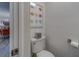 Powder room with a view of the dining room, featuring colorful artwork at 2700 Bayshore Blvd # 588, Dunedin, FL 34698