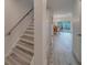 Inviting staircase with modern gold handrail and light wood flooring in home interior at 2700 Bayshore Blvd # 588, Dunedin, FL 34698