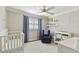 Cozy bedroom with neutral color scheme, comfortable armchair, and ample natural light at 3006 W Angeles St, Tampa, FL 33629