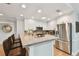 Bright kitchen features stainless steel appliances, granite countertops, breakfast bar, and white cabinetry at 3006 W Angeles St, Tampa, FL 33629