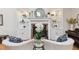Chic living room featuring a fireplace with marble surround, built-in shelving, and stylish decor at 3006 W Angeles St, Tampa, FL 33629