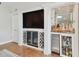 Living room with custom built-ins including wine rack, mini refrigerator, and bar at 3006 W Angeles St, Tampa, FL 33629