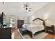 Cozy main bedroom features a vaulted ceiling, ceiling fan, hardwood floors and a plush bed at 3006 W Angeles St, Tampa, FL 33629