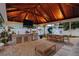The outdoor kitchen under a pavilion features a built-in grill, sink, and seating area, perfect for entertaining at 3006 W Angeles St, Tampa, FL 33629