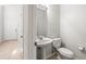 Powder room with pedestal sink, toilet, and neutral paint at 30103 Mossbank Dr, Wesley Chapel, FL 33543