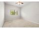 Well-lit bedroom with ceiling fan and natural light from the window creates a cozy atmosphere at 30103 Mossbank Dr, Wesley Chapel, FL 33543