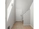 Entryway with a white front door, tile flooring, and carpeted stairs to the second level at 30103 Mossbank Dr, Wesley Chapel, FL 33543