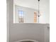 The hallway has two windows, carpet, and a modern chandelier at 30103 Mossbank Dr, Wesley Chapel, FL 33543