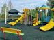 Community playground features colorful slides, climbing structures, and shaded areas at 30103 Mossbank Dr, Wesley Chapel, FL 33543