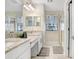 Bathroom featuring double vanities with granite countertops and walk-in shower at 30300 Southwell Ln, Wesley Chapel, FL 33543