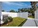 Backyard with green grass and a white fence offers an outdoor space for relaxation at 3402 E 28Th Ave # 4, Tampa, FL 33605
