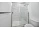 Modern bathroom featuring a glass-enclosed shower and marble-style tiling at 3402 E 28Th Ave # 4, Tampa, FL 33605