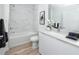Bright bathroom features a combined tub and shower with marble tiling and modern fixtures at 3402 E 28Th Ave # 4, Tampa, FL 33605