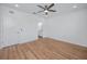 This bedroom features wood-look floors, a ceiling fan, and a connecting bathroom at 3402 E 28Th Ave # 4, Tampa, FL 33605