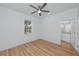 Bright bedroom features a ceiling fan, wood flooring, and ensuite bathroom for added convenience at 3402 E 28Th Ave # 4, Tampa, FL 33605