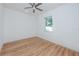 Bright bedroom with wood-look floors, ceiling fan, and large window at 3402 E 28Th Ave # 4, Tampa, FL 33605