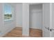 Bedroom with walk-in closet featuring wood-look floors and a window for natural light at 3402 E 28Th Ave # 4, Tampa, FL 33605