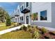 Contemporary townhome exterior showcasing modern design with lush landscaping and vibrant flowers at 3402 E 28Th Ave # 4, Tampa, FL 33605