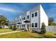 Modern townhomes with gray and white exterior, black awnings, and landscaped front yards at 3402 E 28Th Ave # 4, Tampa, FL 33605
