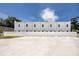 A modern apartment complex with a freshly paved parking area and secure privacy fence at 3402 E 28Th Ave # 4, Tampa, FL 33605