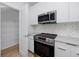 Modern kitchen with stainless steel appliances, quartz countertops, and decorative backsplash at 3402 E 28Th Ave # 4, Tampa, FL 33605