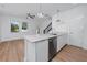 Eat-in kitchen features stainless appliances, quartz counters, and breakfast bar seating at 3402 E 28Th Ave # 4, Tampa, FL 33605