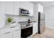 Modern kitchen features stainless steel appliances, white cabinets, and stylish backsplash at 3402 E 28Th Ave # 4, Tampa, FL 33605