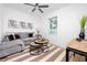 Cozy living room with comfortable seating, ceiling fan, and natural light from the window at 3402 E 28Th Ave # 4, Tampa, FL 33605