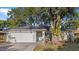 Charming single-story home with a well-maintained lawn, mature trees, and a two-car garage, offering great curb appeal at 3601 Player Dr, New Port Richey, FL 34655