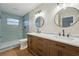 Modern bathroom featuring a double vanity, marble countertops, and a tiled walk-in shower at 4065 38Th S St, St Petersburg, FL 33711