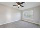 A bedroom with a ceiling fan, neutral carpet, and a window at 4065 38Th S St, St Petersburg, FL 33711