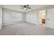 Large bedroom featuring neutral carpet, a ceiling fan and a light-filled en-suite bathroom at 4065 38Th S St, St Petersburg, FL 33711