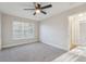Bedroom features a ceiling fan and large window, providing ample natural light at 4065 38Th S St, St Petersburg, FL 33711