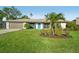 Charming single-story home with a well-manicured lawn and a bright blue front door at 4065 38Th S St, St Petersburg, FL 33711