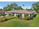 Charming single story home features manicured front lawn and tropical landscaping at 4065 38Th S St, St Petersburg, FL 33711