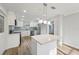 Modern white kitchen with an island, stainless steel appliances, and great light fixtures at 4065 38Th S St, St Petersburg, FL 33711