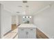 Bright kitchen island with white countertop and cabinets with views to the front yard at 4065 38Th S St, St Petersburg, FL 33711