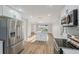 Modern kitchen with an island, stainless steel appliances, and open flow to the living area at 4065 38Th S St, St Petersburg, FL 33711