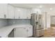 Bright kitchen featuring white cabinets, stainless steel appliances, and stylish subway tile backsplash at 4065 38Th S St, St Petersburg, FL 33711