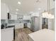 Modern kitchen with stainless steel appliances, white cabinets, and plenty of countertop space at 4065 38Th S St, St Petersburg, FL 33711