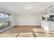 Sun-drenched living space featuring wood-look floors, large windows, and modern kitchen at 4065 38Th S St, St Petersburg, FL 33711