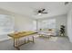 Living room with a ceiling fan, multiple windows, and minimal decor at 4065 38Th S St, St Petersburg, FL 33711