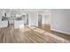 Bright living room with wood-look floors connecting seamlessly with a modern kitchen at 4065 38Th S St, St Petersburg, FL 33711