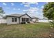 The backyard features a well-maintained lawn, privacy fence, and a covered patio area at 4307 Dristol Ave, Spring Hill, FL 34609