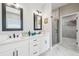 Bright bathroom features a double vanity, frameless mirrors, a glass shower, and sleek design at 4307 Dristol Ave, Spring Hill, FL 34609
