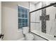 Modern bathroom featuring shower and tub with white marble and mosaic tile accents at 4307 Dristol Ave, Spring Hill, FL 34609